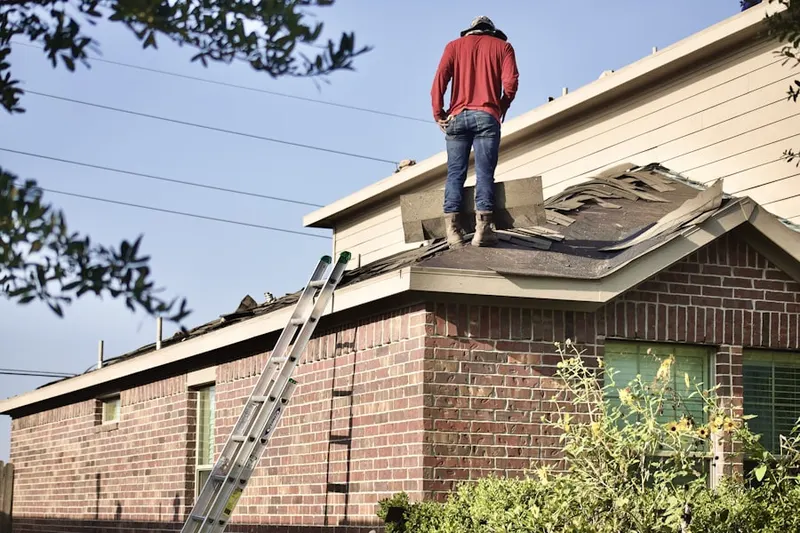 Professional roofer working on a residential roof in CHANT